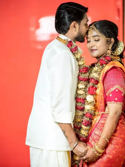 A tender moment. The groom's hairstyle is set to stay perfect even through the long hours of the wedding ceremony.
