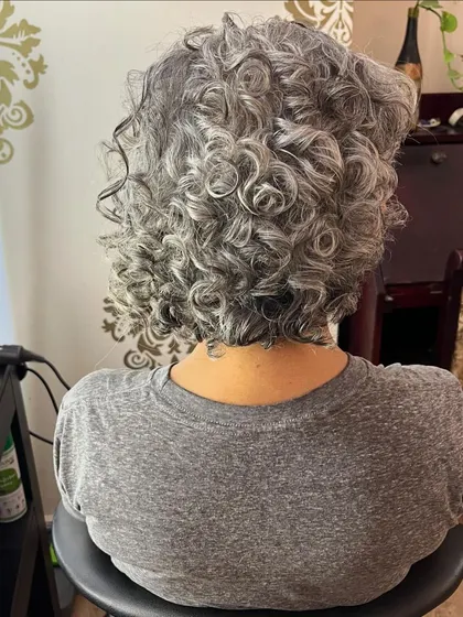 The back view shows how the curls are shaped to create a full, voluminous look.