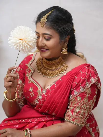 The joy of dressing up for a special occasion. Our client looks beautiful in this red embroidered lehenga, perfect for making memories.