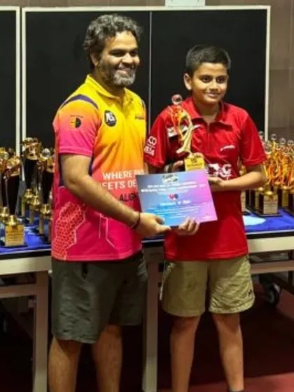 A young winner with his trophy and certificate. Recognizing every player's effort is a key part of my tournament philosophy.