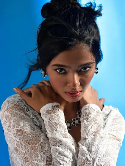 A powerful, direct portrait that showcases the jewellery in a high-fashion context. The intense gaze adds a layer of drama to the commercial shot.