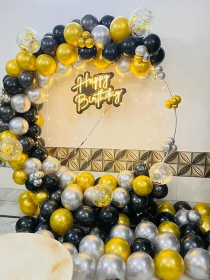 A classic black, gold, and silver balloon ring with a neon sign, perfect for any elegant party.