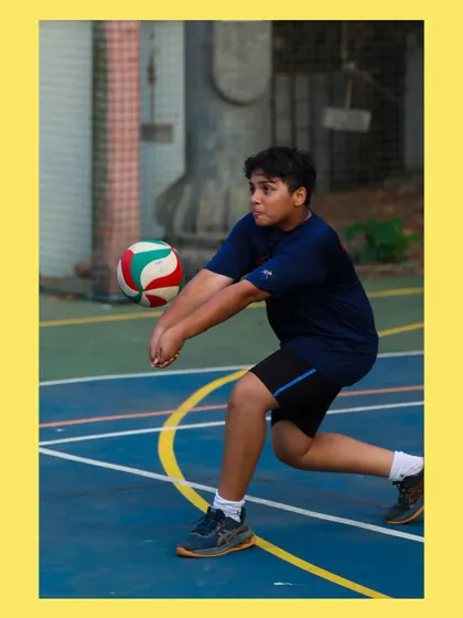 A young player gets low to execute a controlled bump pass. We teach the importance of proper body mechanics in every drill.