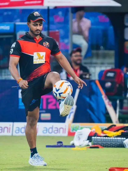 A close-up of me juggling a football on the field. This is a great way to stay sharp, improve balance, and keep the warm-up engaging and fun.