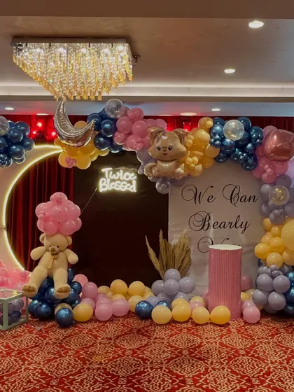 This photo provides a clear view of all the elements working together, from the teddy bear on the left to the balloon arch and backdrop on the right.
