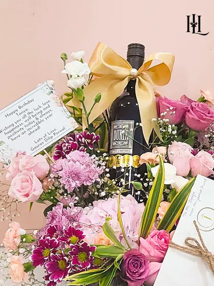 A birthday hamper that combines sophistication with personal touches. This arrangement features a bottle of Durville wine, a beautiful bouquet of fresh flowers, and a spa voucher, making it a perfect gift for relaxation and celebration.