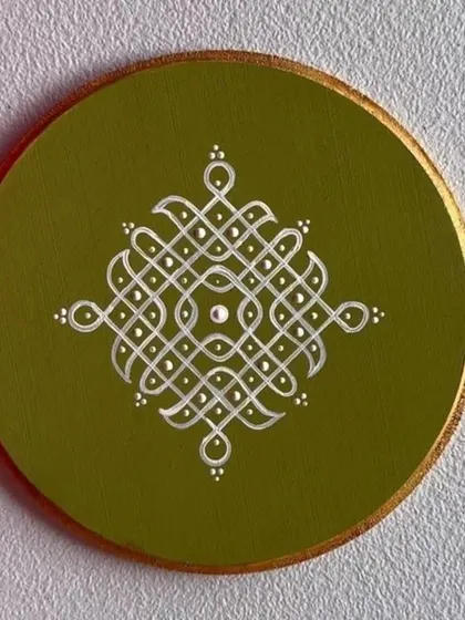 A hand-painted coaster featuring a traditional Kolam design. These small art pieces are perfect for festive gifting or for adding a touch of South Indian tradition to your home.