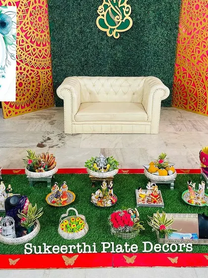 A complete engagement ceremony setup, featuring my decorated plates, Uppukudai, and thematic dolls, all arranged on a neat grass mat.