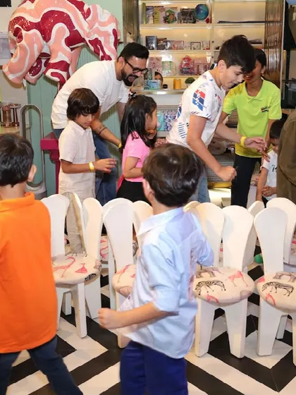 Our games coordinator leads a lively game of musical chairs, ensuring all the kids are engaged and having fun.
