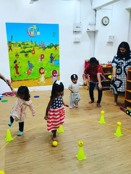 Look at the focus! This indoor game involves running and collecting balls, which helps with agility and color recognition. It's amazing to see how engaged they are in the task.