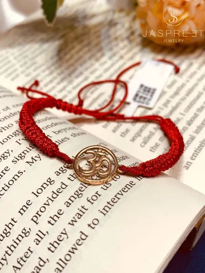 The sacred Om symbol, crafted in 14kt gold and set on a traditional red thread. This bracelet is a simple yet powerful piece of spiritual jewelry, perfect for daily wear or as a thoughtful gift.