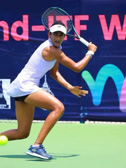 An action shot showcasing our athlete's dynamic movement and perfect form while hitting a forehand on the run during a hard-court tournament.