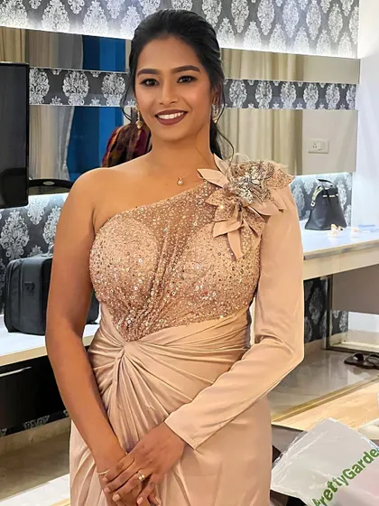 Exuding classic glamour, this client is ready for any special occasion in her one-shoulder sequined gown. The makeup is sophisticated and polished, with a simple yet elegant hairstyle.