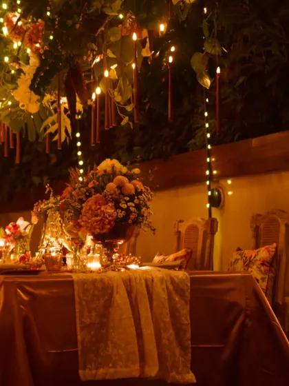 The stunning, candle-lit tablescape for Anushka Sharma's private birthday dinner. The decor was designed to create a warm, magical, and intimate atmosphere.