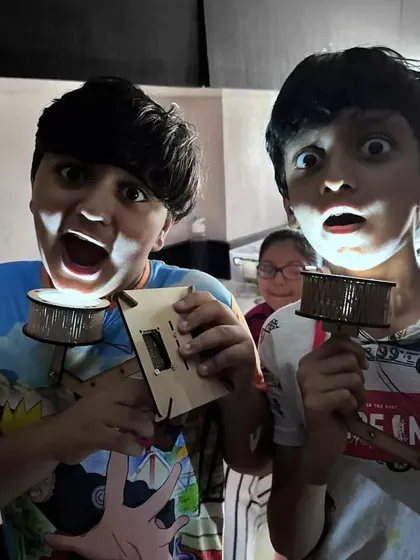 The look of pure excitement and discovery is what we aim for in every session. Here, our students proudly show off the electronic torch projects they built from scratch during one of our hands-on workshops.