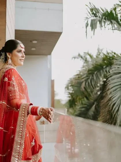 The bride takes a quiet moment on the balcony before her ceremony. This candid portrait captures her in a natural, thoughtful pose.