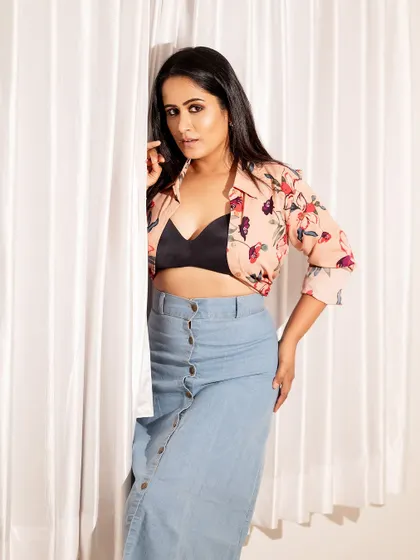 A more direct and confident pose from the same shoot. The white curtain background is simple and effective.