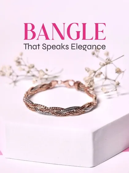 Grace your wrists with this timelessly elegant braided bangle, a beautiful blend of rose gold and silver tones.