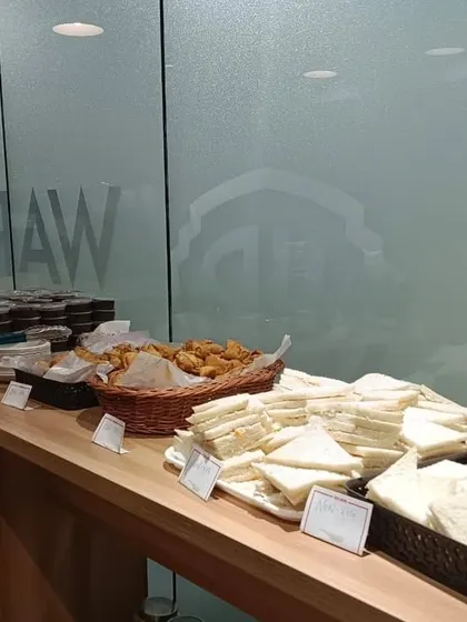A full view of the high-tea setup, showing the neat arrangement of food, labels, and serving ware for a professional and inviting presentation.