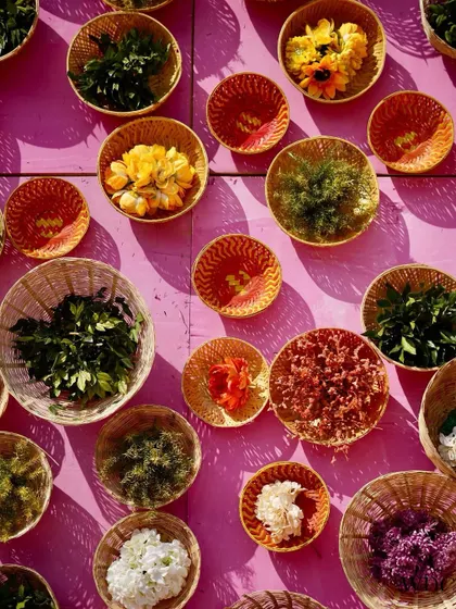 An interactive and beautiful decor element. We created a wall with colorful baskets filled with a variety of fresh flowers and petals, adding a touch of natural beauty and texture.