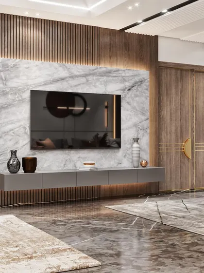 A different angle of the living room, showing the main entrance and the marble-clad TV feature wall.