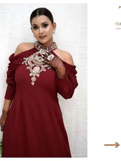 The intricate, jewel-like neckline of this gown means you don't need to worry about accessorizing. It's a complete look in one beautiful piece.