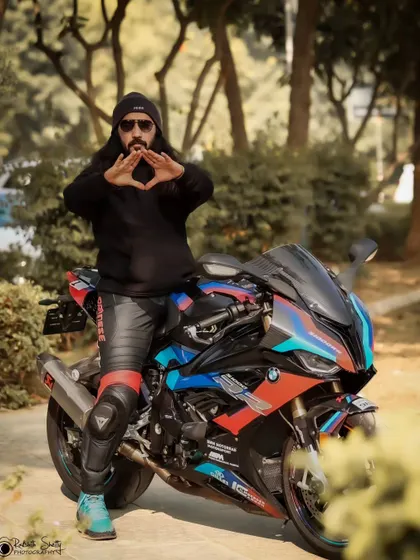 A creative pose with the rider making a hand gesture, adding a unique and personal touch to the automotive portrait.