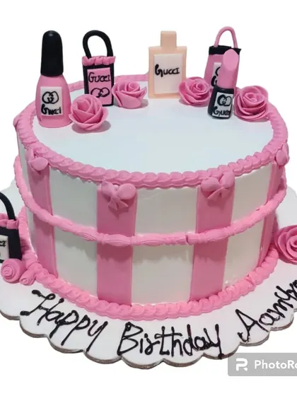 A chic makeup-themed cake for a beauty lover. This design is adorned with edible lipstick, nail polish, and Gucci shopping bags.