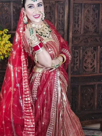 This full-length shot shows a bride in a red sequined lehenga, complemented by a custom green-beaded Kundan jewellery set that adds a touch of traditional elegance.