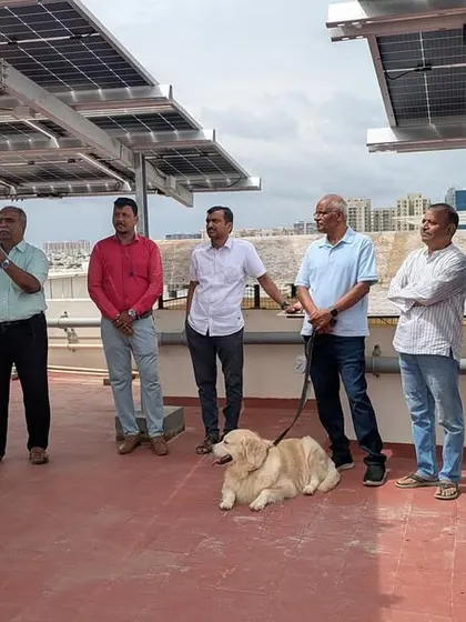Our team discussing the benefits of the new 30 kW solar system with the residents of Shivaprakruthi Society on their rooftop.