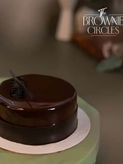 The Chocolate Truffle bento cake, finished with a mirror glaze. Its sleek, simple design makes it a sophisticated choice for any small occasion.