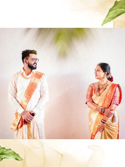 A simple and elegant portrait of the couple standing together, their traditional attire looking beautiful against a clean, white background.