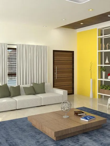 A living hall interior with a bright yellow accent wall and an open shelving unit that acts as a subtle space divider. The design is open and inviting, with a mix of neutral tones and a pop of color.