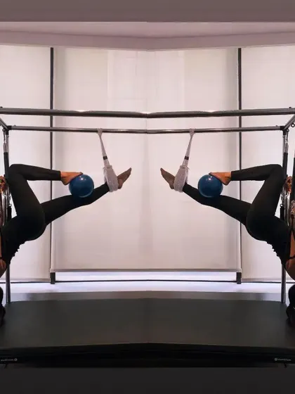 A mirrored image of a hanging inversion, highlighting the symmetry and balance we strive for in Pilates.