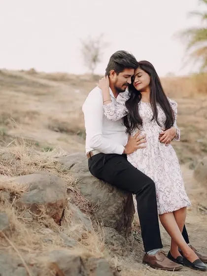 A quiet, tender moment sitting on the rocks in a rustic landscape. This shows the comfortable silence that exists between a loving couple.