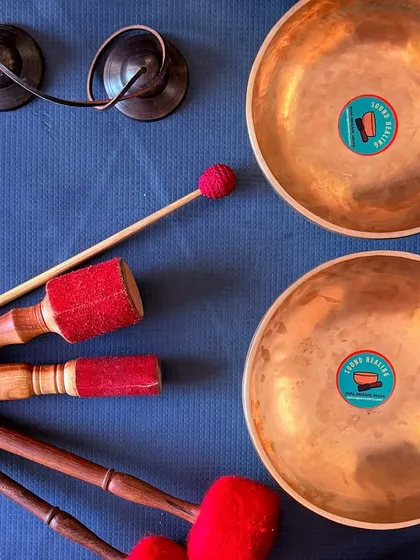 A simple set of healing tools: two handmade singing bowls and a pair of tingsha cymbals. These instruments are fundamental to my sound healing sessions and are perfect for creating a clear, resonant sound.