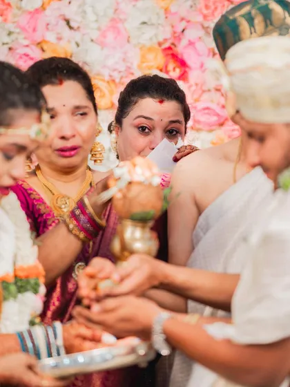 A touching scene during the wedding ceremony. The makeup on both the bride and her mother is designed to be long-lasting and resilient.