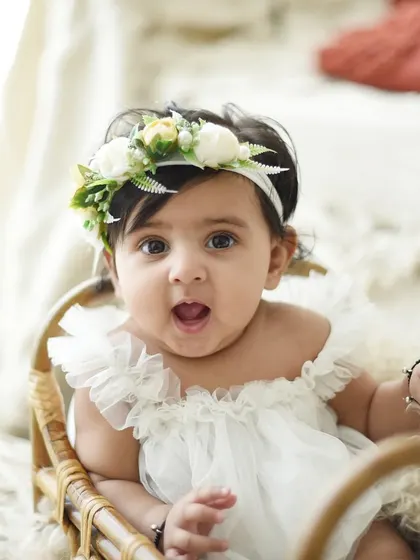 The look of surprise and wonder is priceless. At six months, babies are so expressive, and I love capturing all their different faces. This simple, bright setup keeps the focus on her.