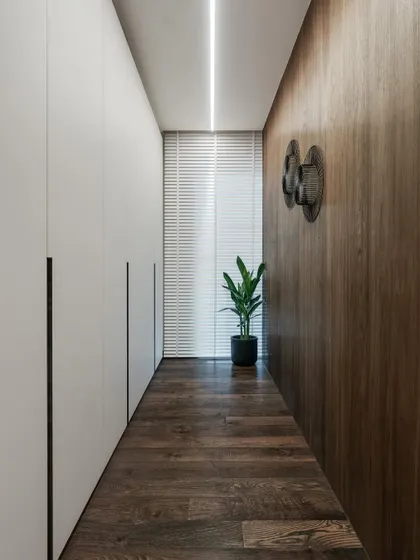 Behind the curved partition lies a clean, minimalist wardrobe space. I focus on maximizing storage and functionality in a way that feels integrated and aesthetically pleasing.
