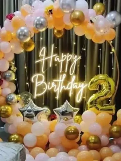 A beautiful ring decoration for a 21st birthday, using peach, white, and gold balloons.