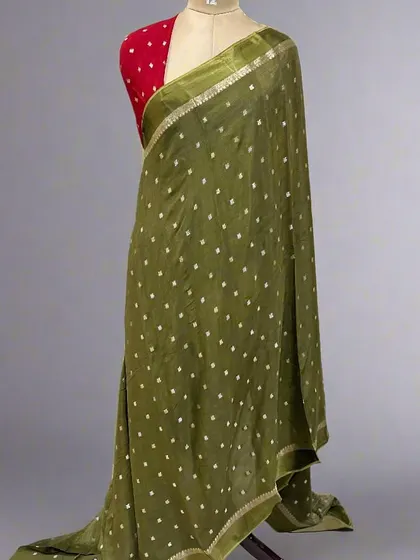 The same beautiful Chinon saree design, this time in a lovely mehndi green. This earthy tone is very versatile and can be dressed up or down for any occasion.