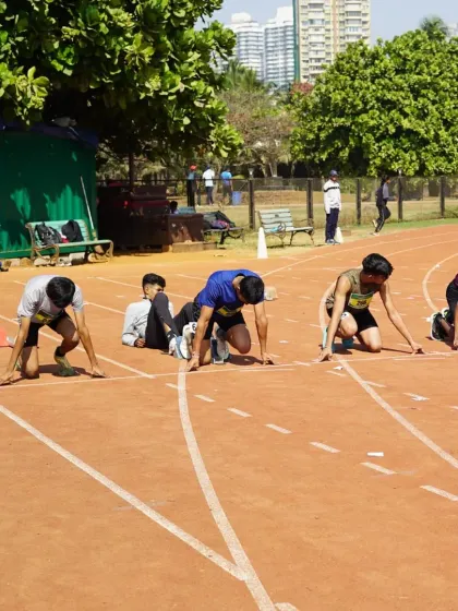 Athletes are in their starting blocks, ready to explode off the line. This photo captures the intense focus and anticipation just moments before a sprint race begins at our championship.
