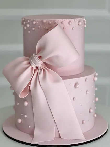 A gorgeous two-tiered pink cake featuring a large, dramatic bow. This design is perfect for a girly celebration and teaches skills in stacking and advanced fondant work.