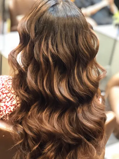 This shows a rich, warm brown balayage with soft waves. The colour is concentrated towards the ends to create a gentle, cascading effect.