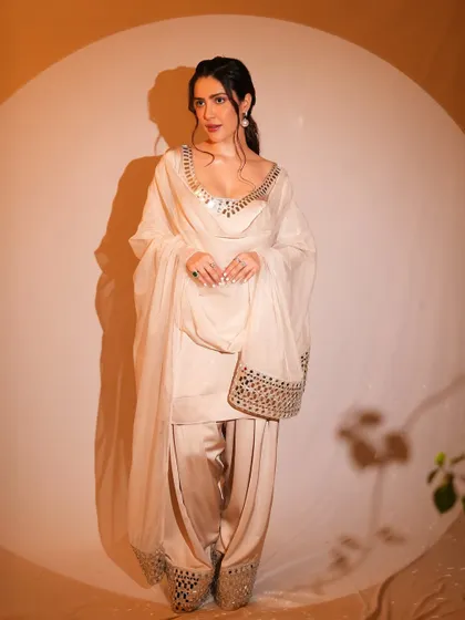 Another angle of this classic look, showing the beautiful mirror work on the outfit. The makeup remains timeless and elegant from every view.
