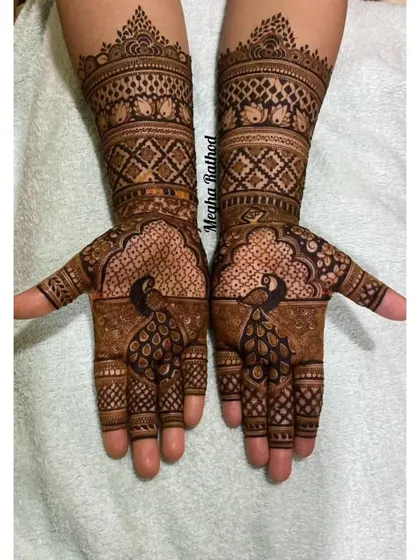 This design showcases majestic peacocks on the palms, with their feathers created from fine, detailed linework. The arms feature classic checkerboard and geometric patterns for a balanced look.