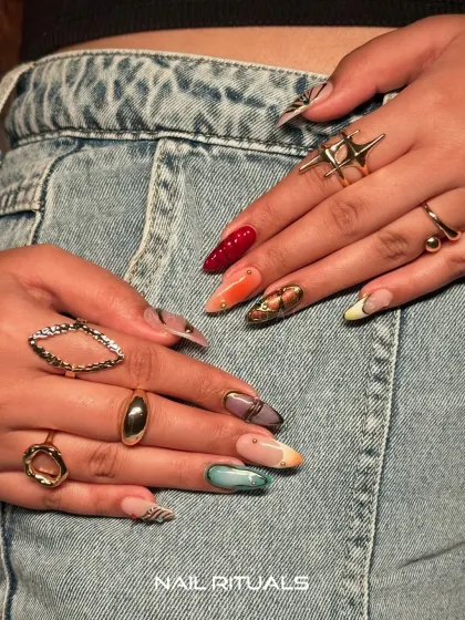 Bold nails paired with a casual denim look. This shot shows how a unique, artistic manicure can elevate any outfit.