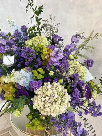 A fuller view of my "Limes and Violets" arrangement. The sprawling design uses delphiniums, daisies, and cymbidium orchids to create a piece that is bursting with color and life.