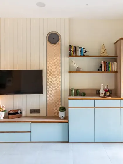 This elegant TV and bar unit becomes the centerpiece of the living room. The design features clean lines, an arched mirror collage, and fluted glass shutters for the temple area.