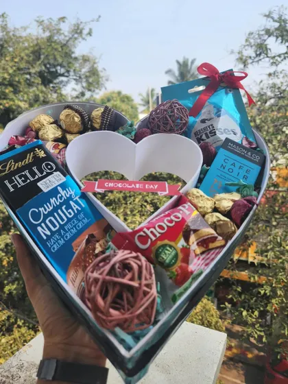 A full color version of our heart-shaped chocolate hamper, showing the vibrant packaging of the treats inside.
